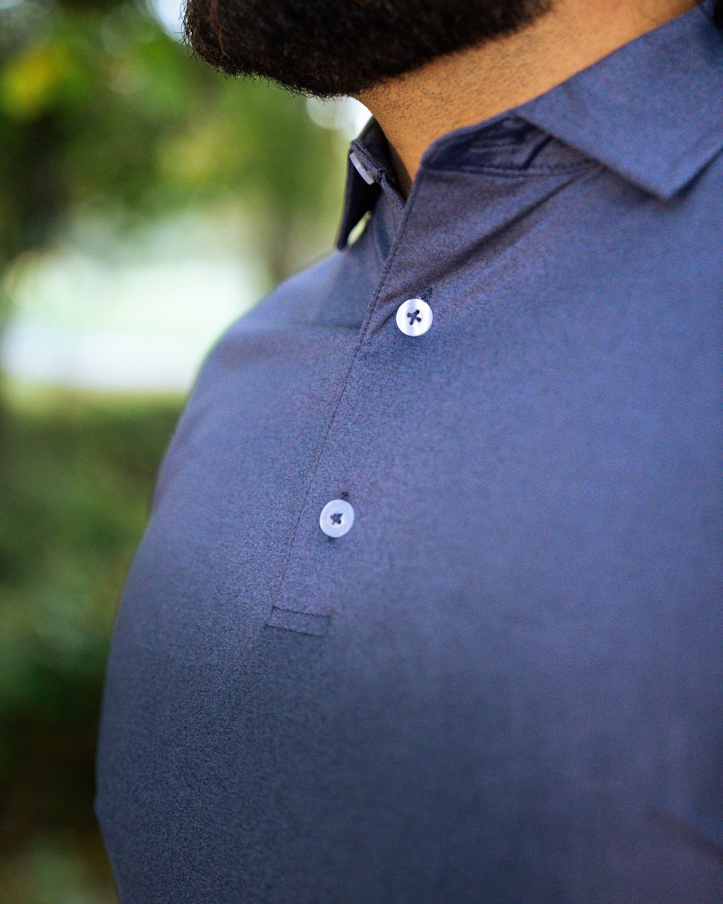 THE HEATHER NAVY PERFORMANCE POLO