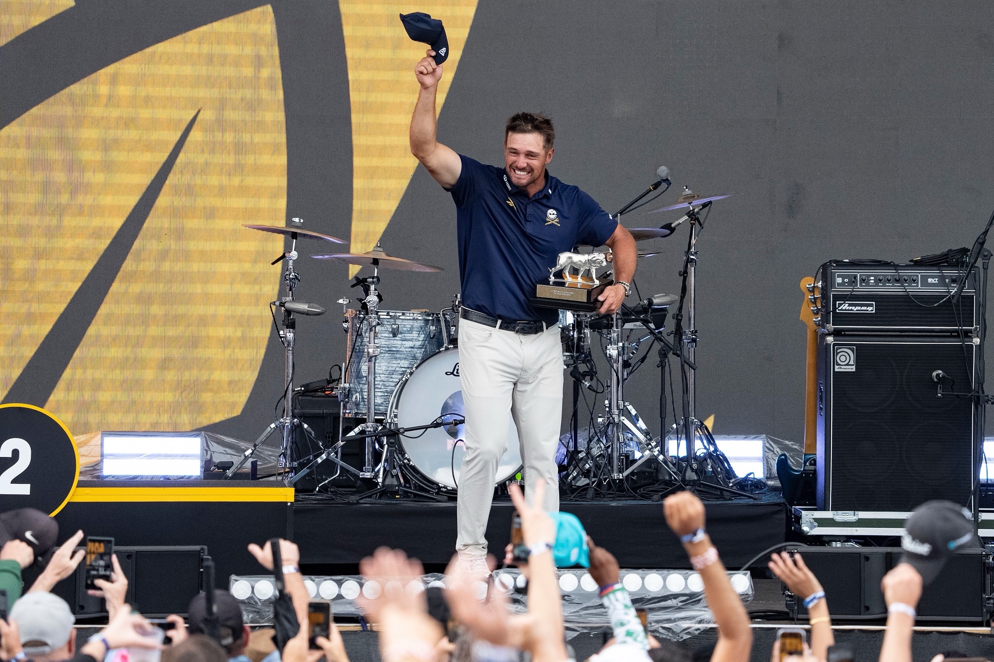 Bryson DeChambeau celebrates with the trophy after winning the LIV Golf individual championship