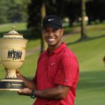 Tiger Woods holds the Bridgestone Invitational trophy at Firestone Country Club in Akron, Ohio