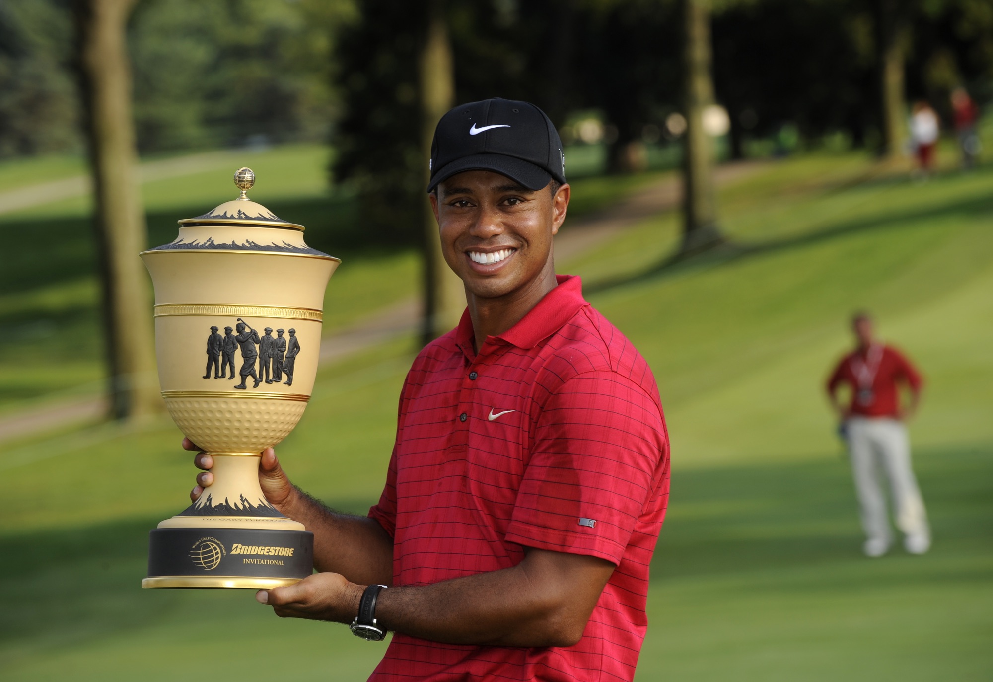 Tiger Woods holds the Bridgestone Invitational trophy at Firestone Country Club in Akron, Ohio