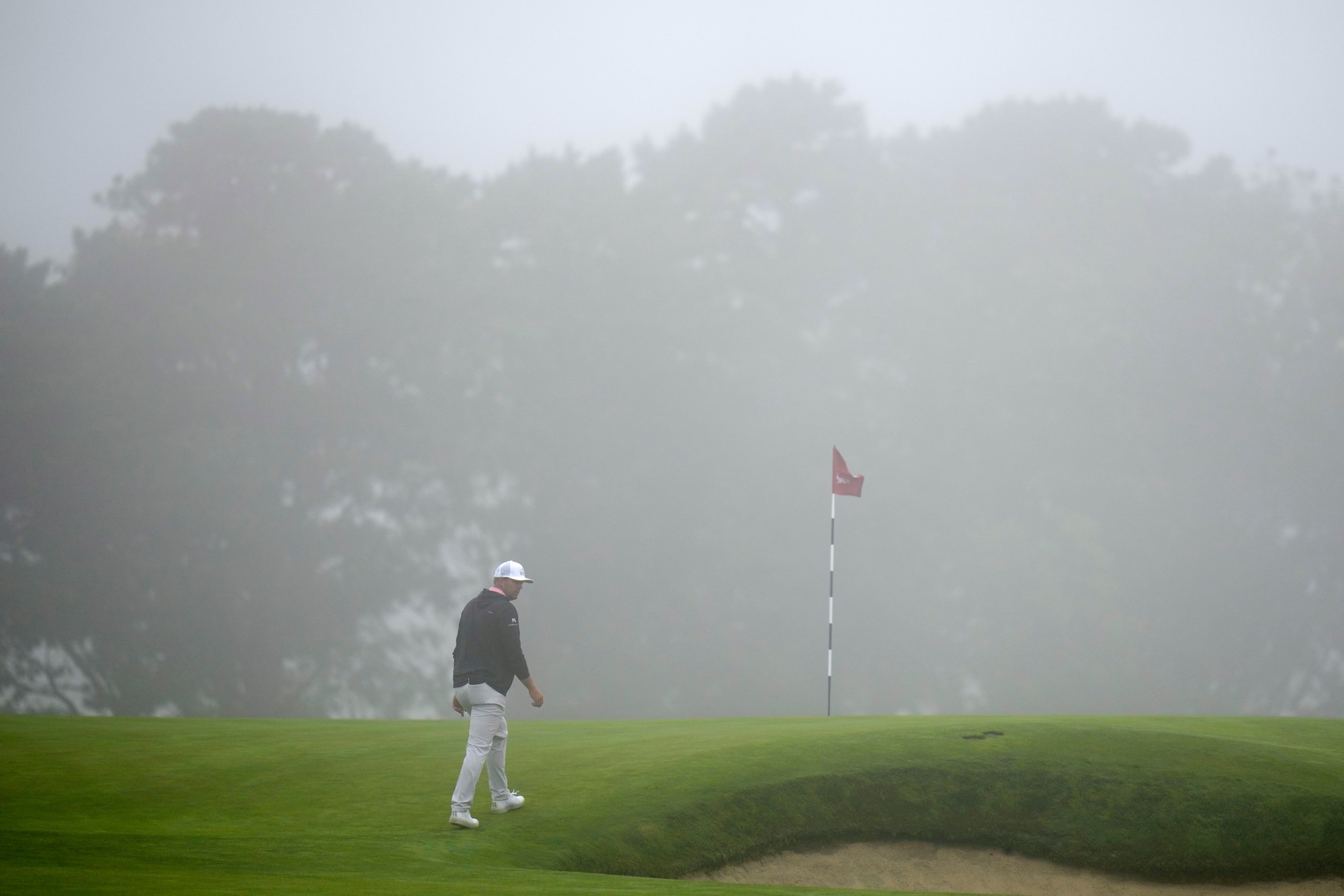 Taylor Montgomery walks to the green on the second hole during the first round of the U.S. Open at Shinnecock Hills Golf Club in Southampton, N.Y.