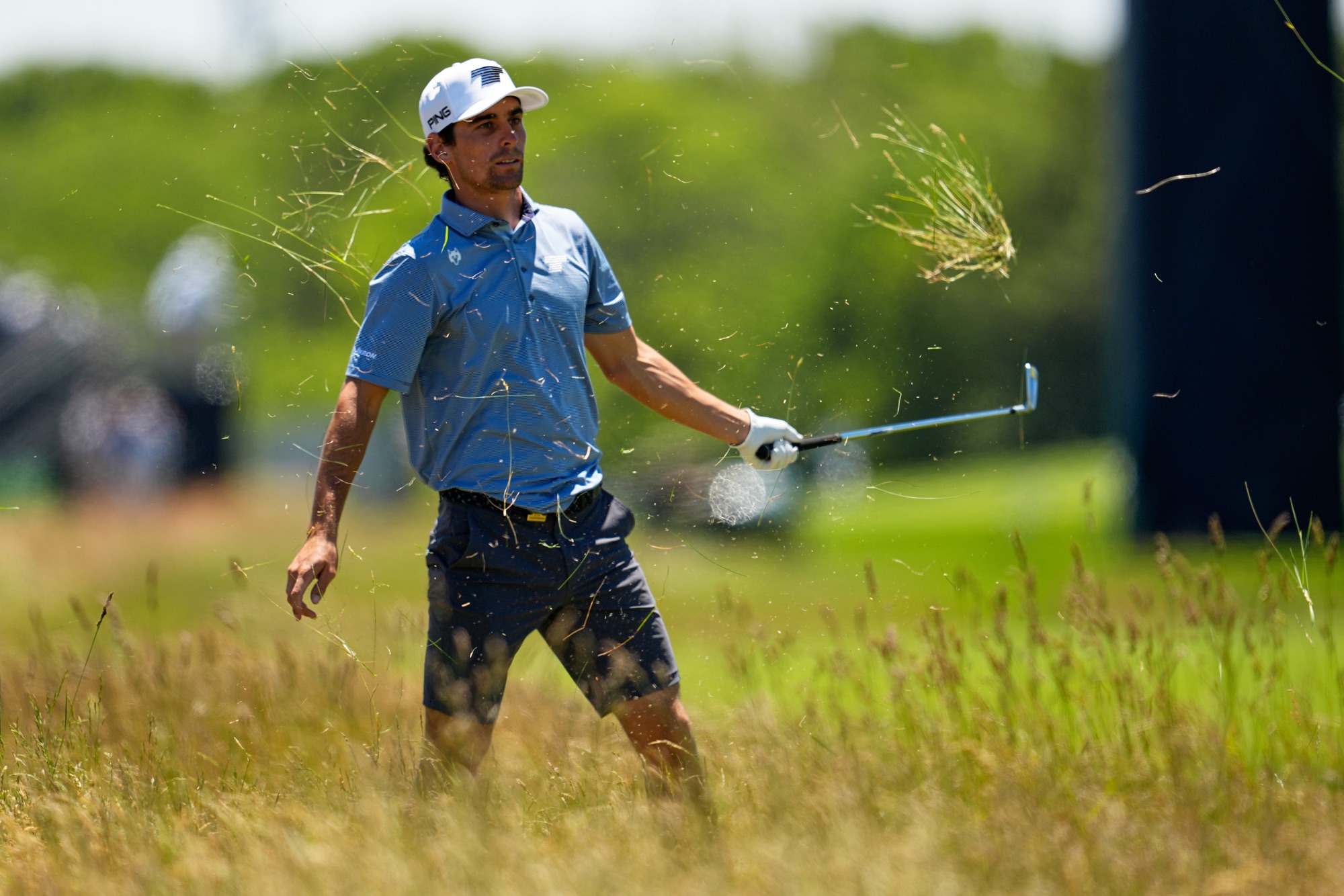 Joaquin Niemann hits from the rough during a practice round at the U.S. Open at Shinnecock Hills