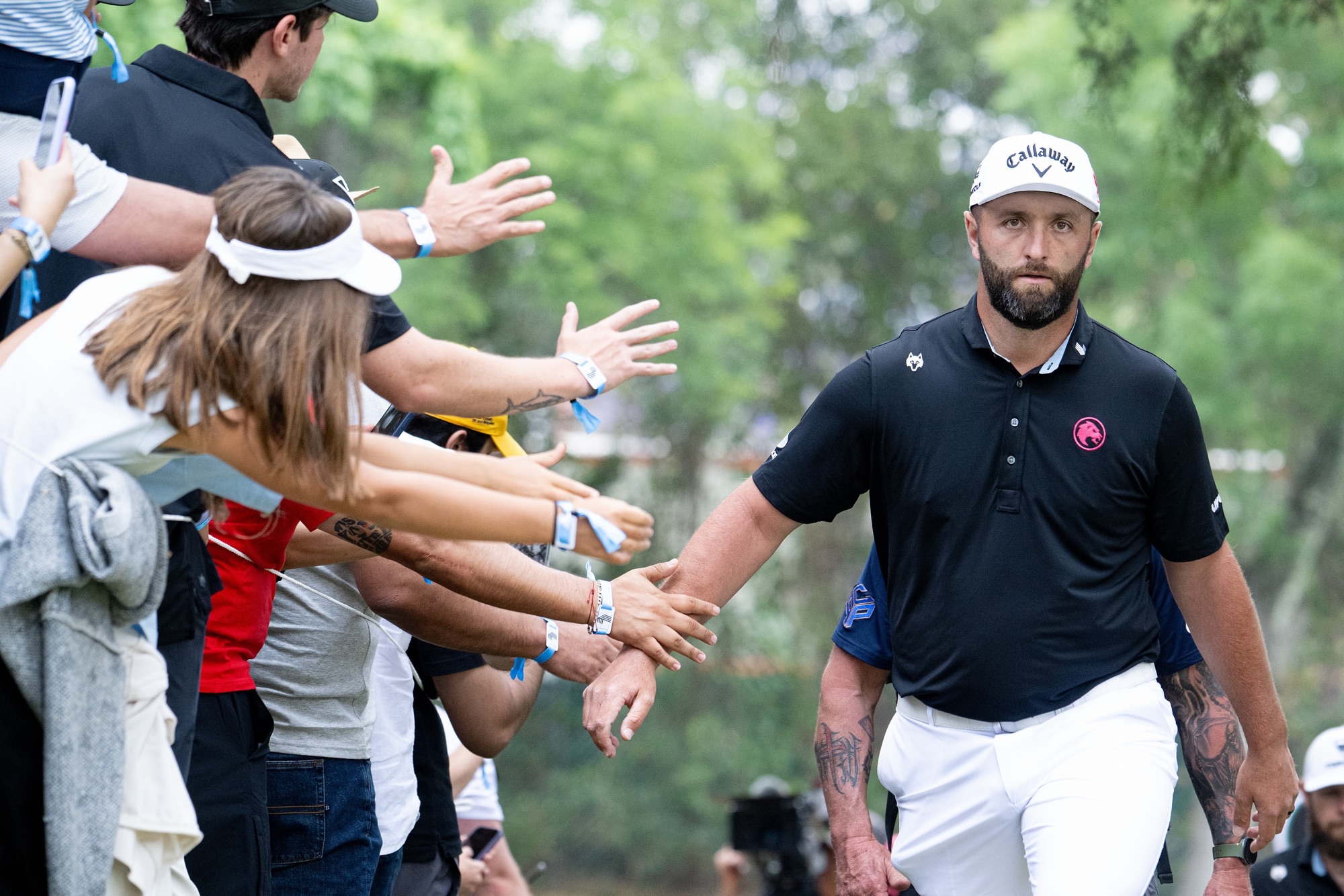Jon Rahm walks to the sixth tee during a LIV Golf event