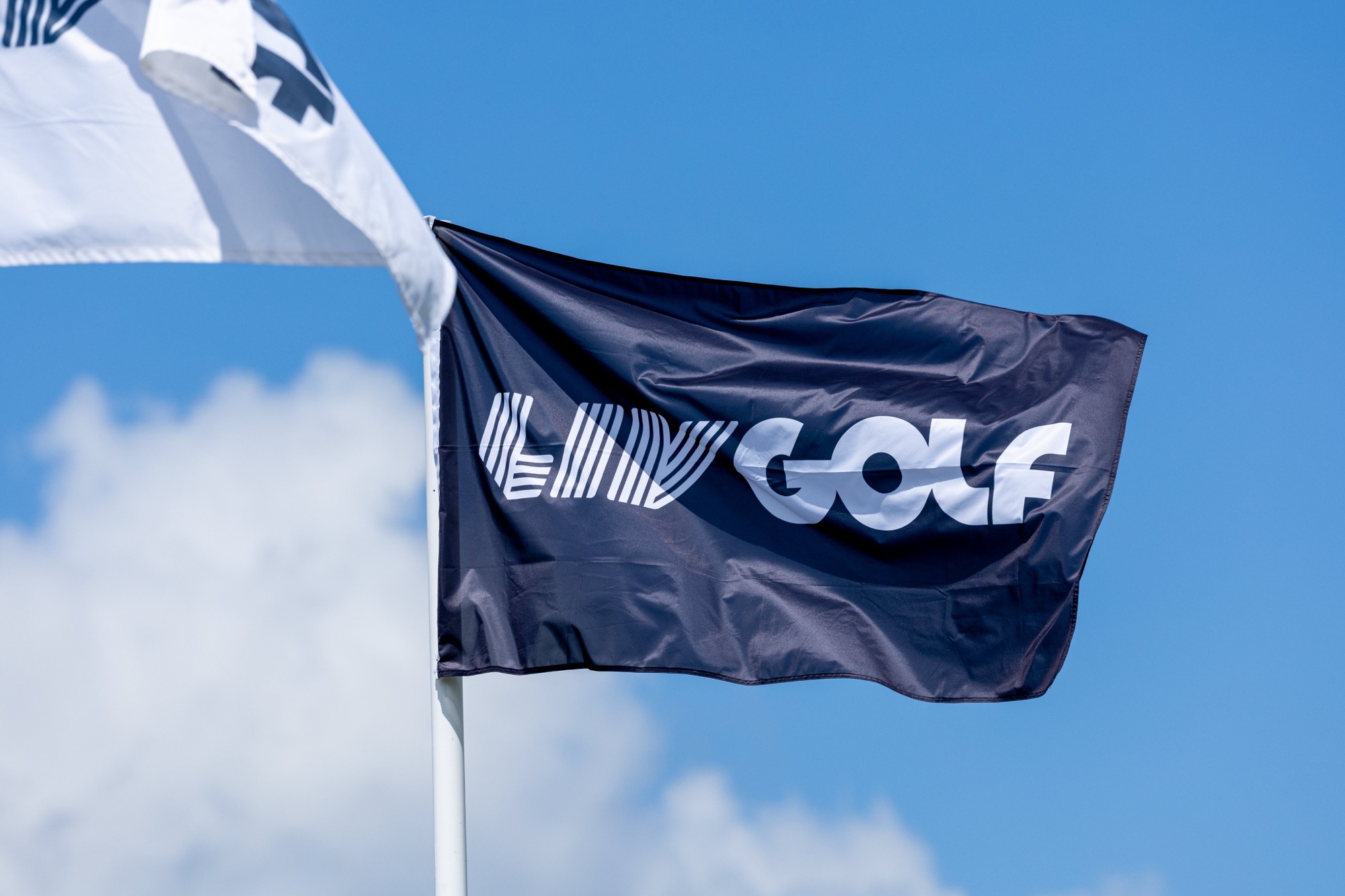 A LIV Golf flag flies at a tournament venue