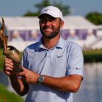 Scottie Scheffler holds the winning trophy after the final round of the FedEx St. Jude Championship on Sunday, Aug. 16, 2026, in Memphis, Tennessee