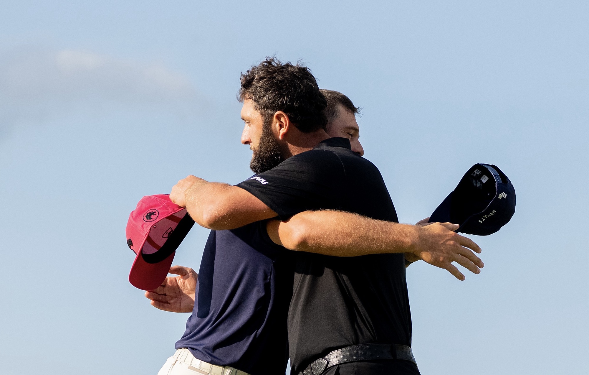 Jon Rahm and Bryson DeChambeau embrace after the final round of LIV Golf Indianapolis at The Club at Chatham Hills