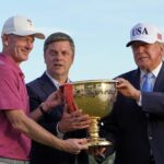 President Donald Trump and PGA Tour CEO Brian Rolapp hand the Presidents Cup trophy to U.S. captain Brandt Snedeker at Medinah Country Club