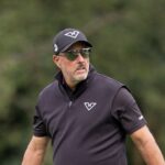 Phil Mickelson walks the first hole during the final round of LIV Golf's event at JCB Golf & Country Club in Rocester, England